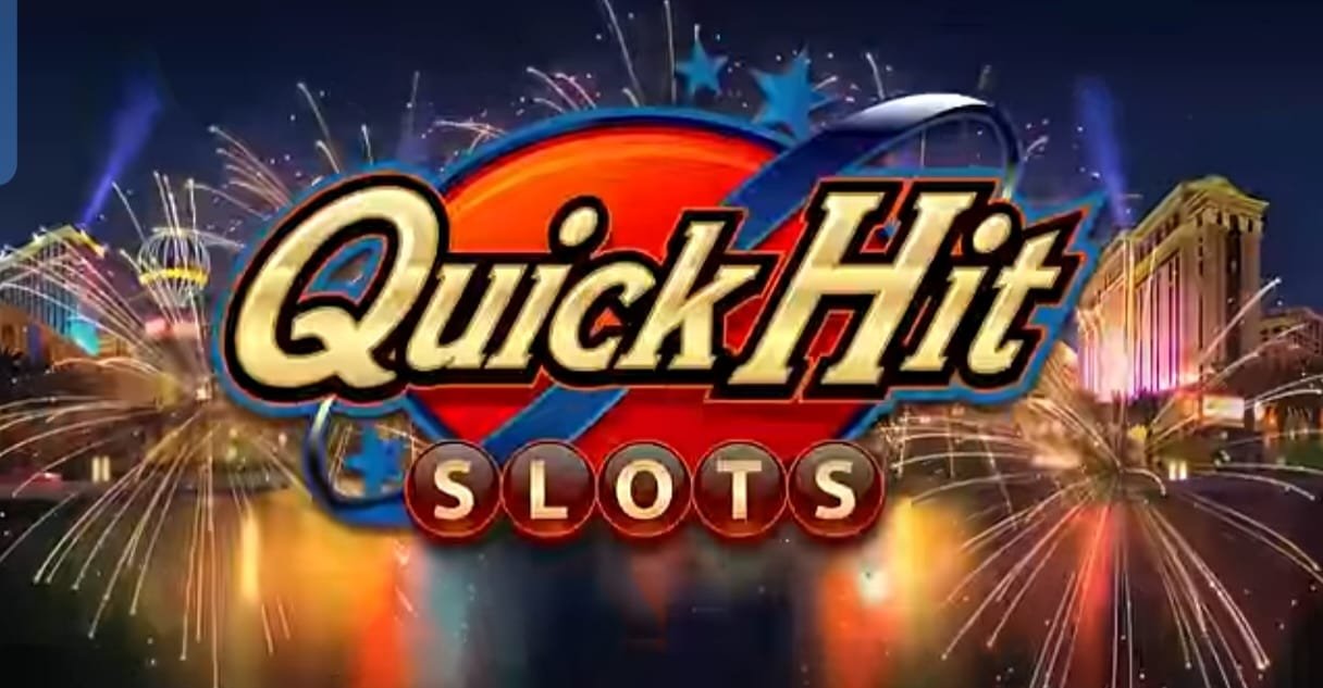 Logo of "Quick Hit Slots" featuring bold yellow and red text over a vibrant background with fireworks, lights, and a cityscape resembling Las Vegas, indicating a festive and casino-themed atmosphere.